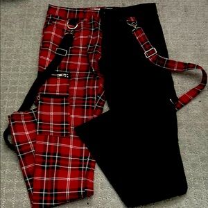 Red plaid/ Black jeans with hanging suspenders.